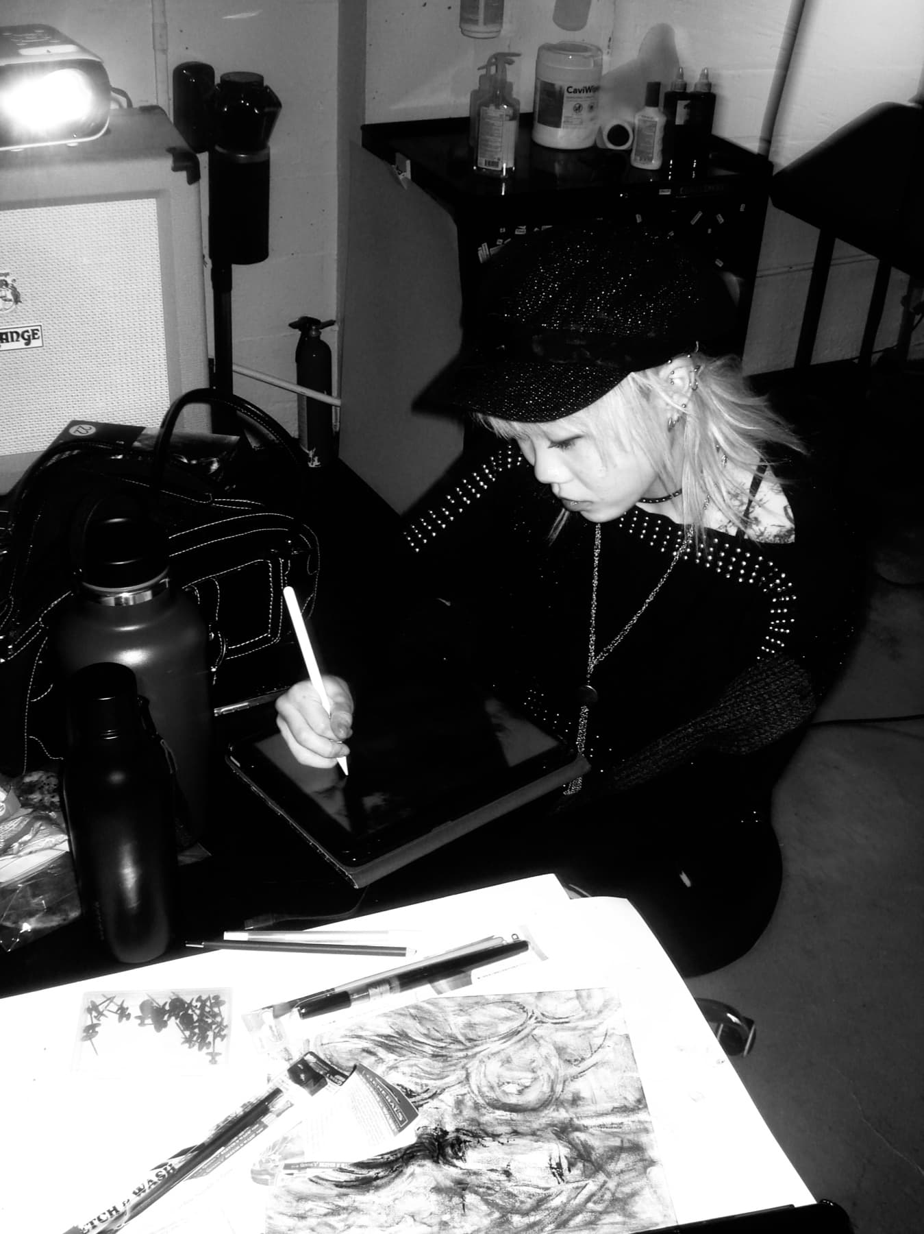 Esther sketching on a tablet in her studio