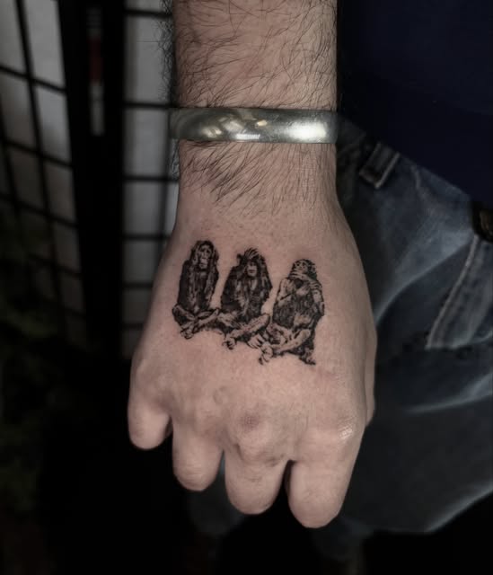 three monkeys tattoo on the back of a hand